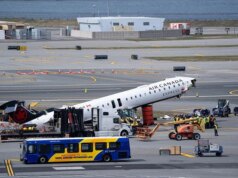 Destroços do avião da Air Canada acidentado sendo retirados da pista do Aeroporto LaGuardia