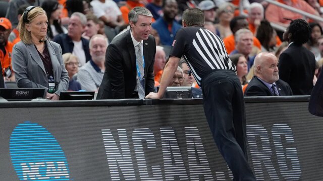 ncaa-referee-at-scorers-table.jpg